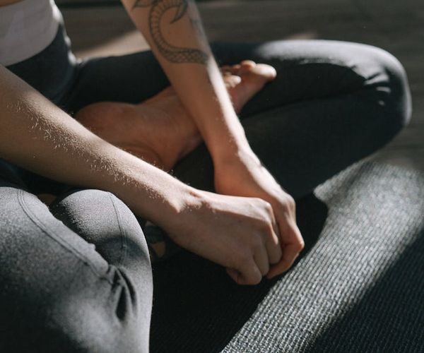 Close-up of a person's hands in a meditative pose, focusing on breath.
